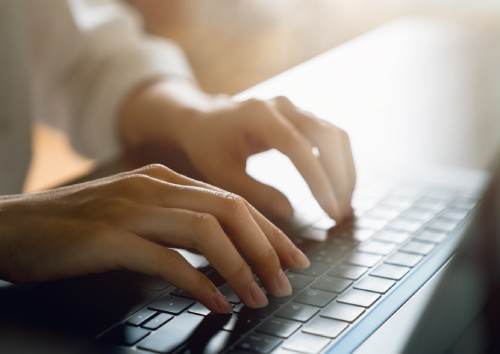 Image of a person typing on a keyboard